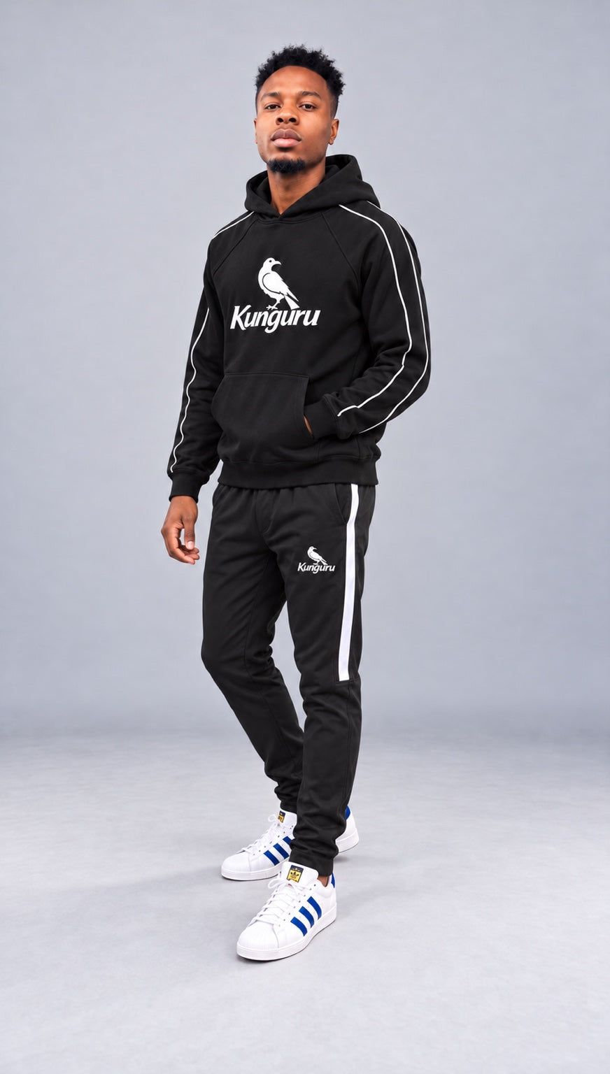Model showcasing black Kunguru hoodie and matching striped track pants